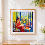 Finished woman by window with fruit cross stitch artwork displayed