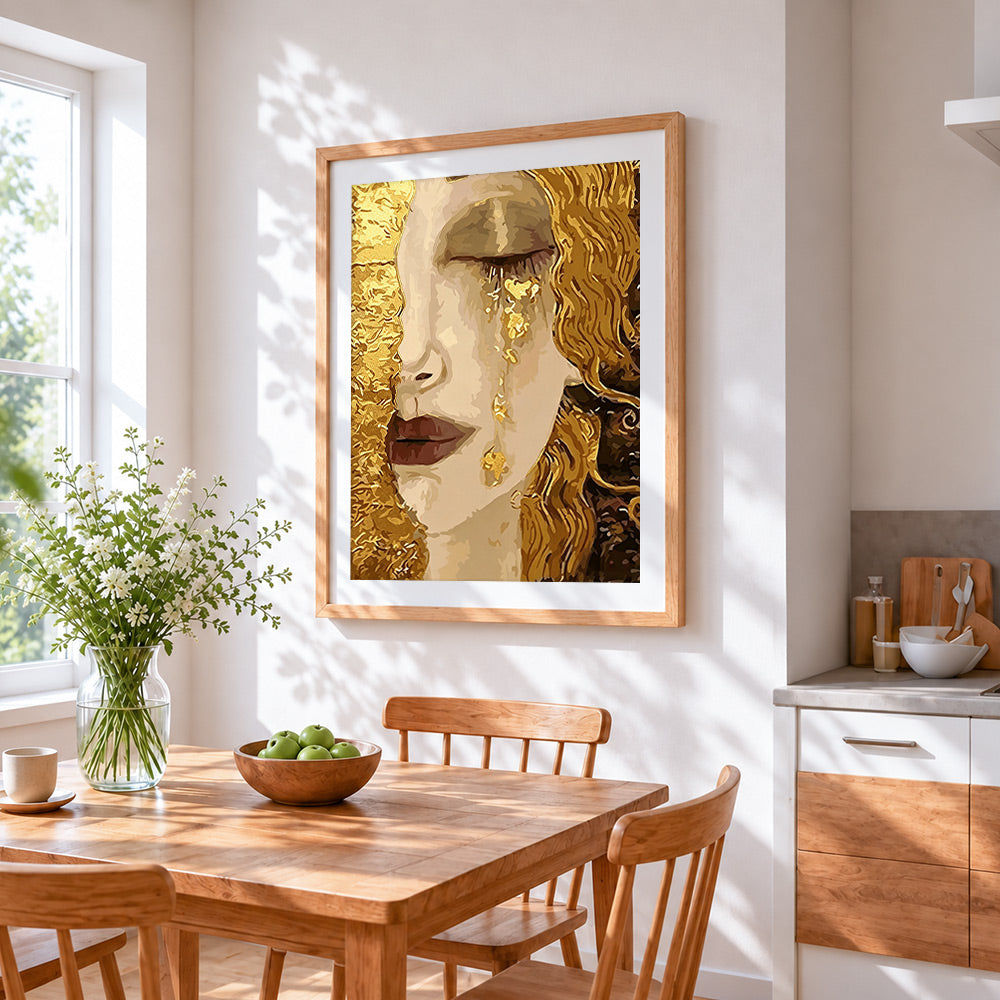 Woman crying golden tears cross stitch artwork displayed on wall as home decor
