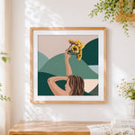 Finished woman holding sunflowers cross stitch artwork displayed