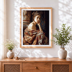 Finished woman in floral wrap cross stitch artwork displayed