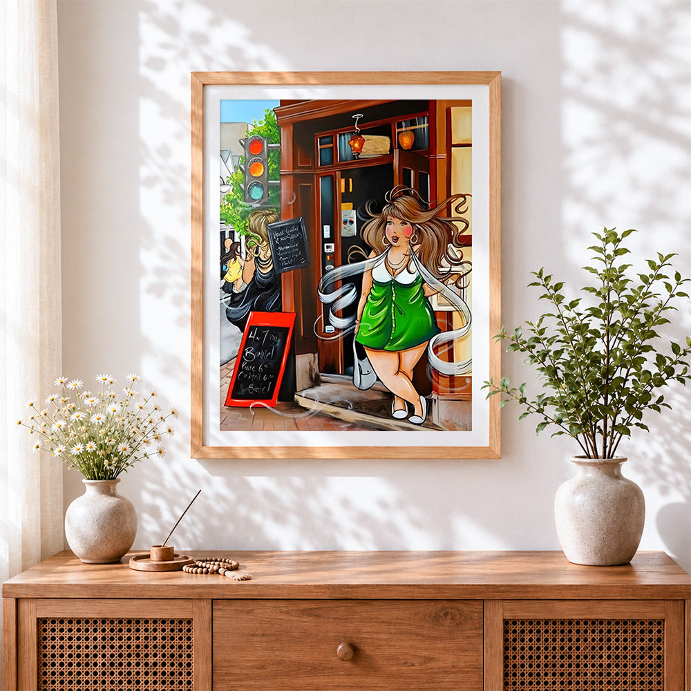 Finished woman in green dress on street cross stitch artwork displayed