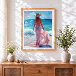 Finished woman in pink dress at beach cross stitch artwork displayed