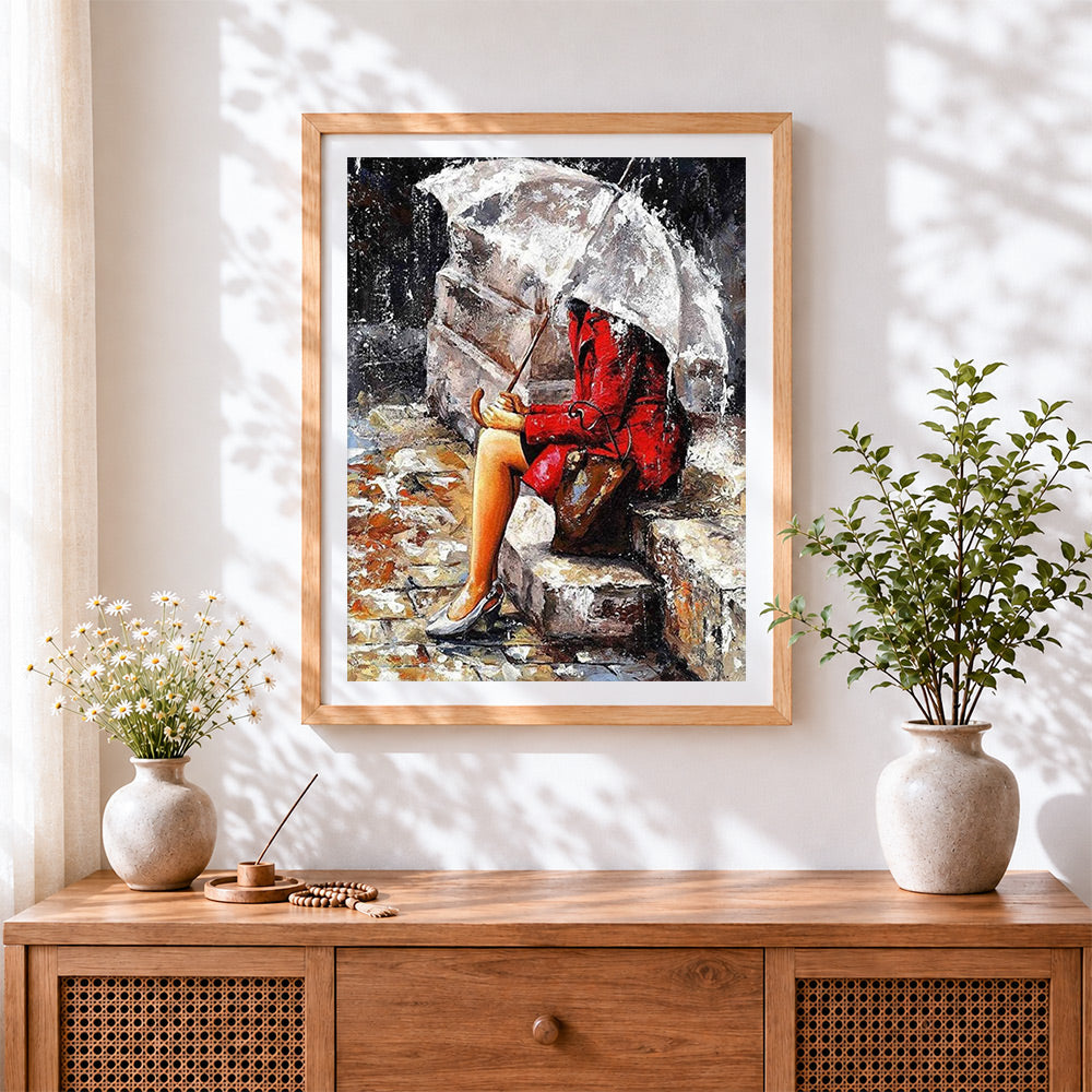 Finished woman in red coat in the rain cross stitch artwork displayed