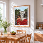 Woman in red dress by waterfall cross stitch artwork displayed on wall as home decor