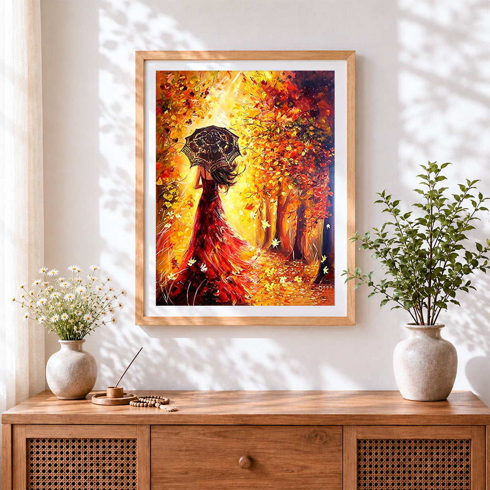 Finished woman in red dress with umbrella in autumn cross stitch artwork displayed