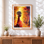 Finished woman in red dress with umbrella in autumn cross stitch artwork displayed