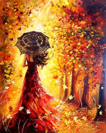 Woman in red dress with umbrella in autumn cross stitch kit for beginners