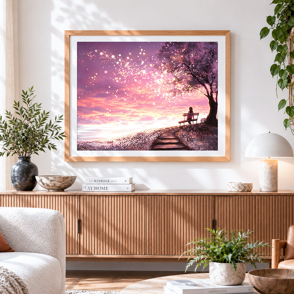 Finished woman on a bench under cherry blossoms cross stitch artwork displayed
