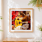 Finished Woman with acoustic guitar cross stitch artwork displayed