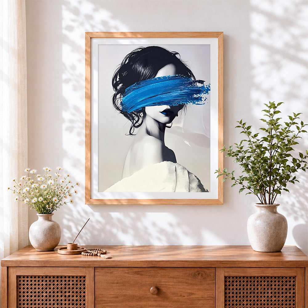 Finished woman with blue brushstroke cross stitch artwork displayed