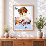 Finished woman with butterflies on back cross stitch artwork displayed