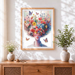 Finished woman with exploding floral hair cross stitch artwork displayed