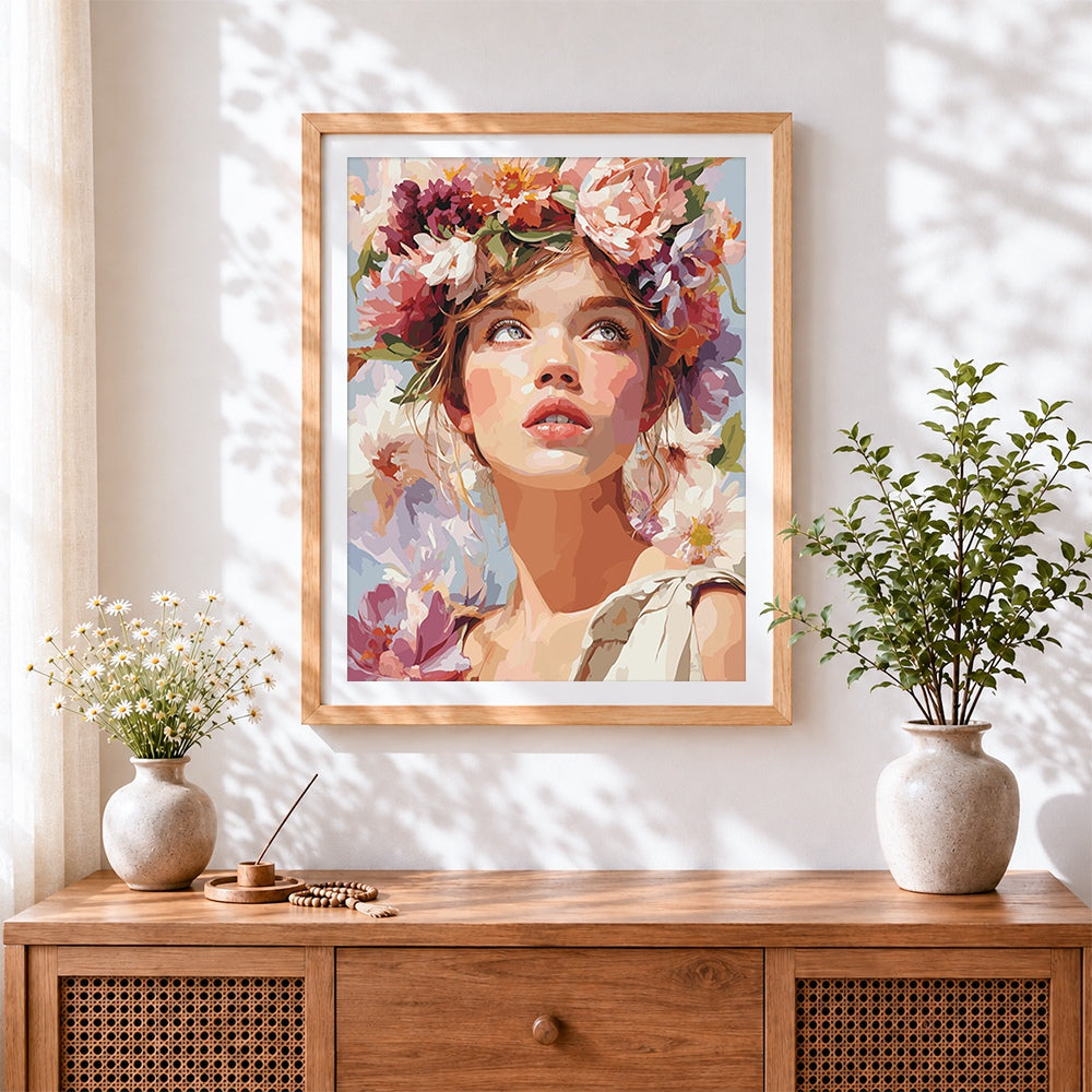 Finished woman with flower crown looking up cross stitch artwork displayed