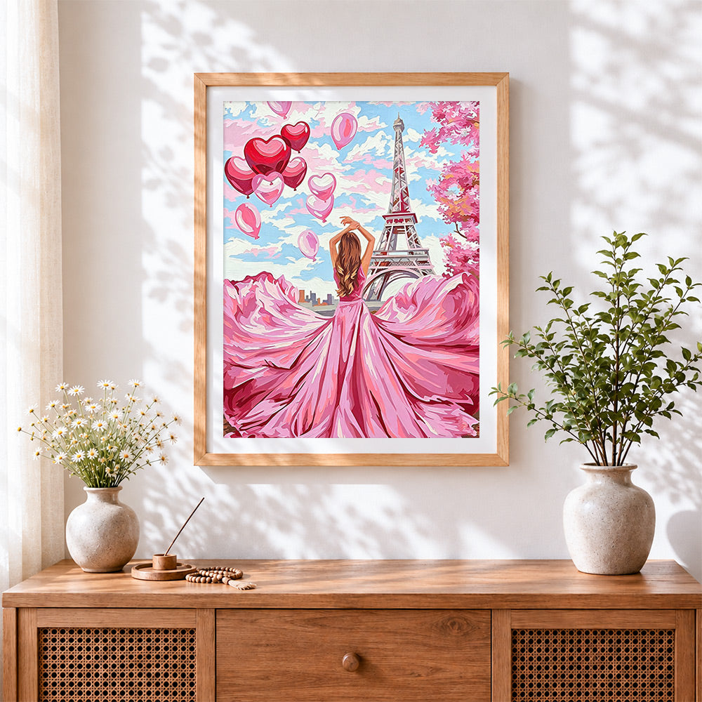 Finished woman with heart balloons cross stitch artwork displayed