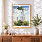 Finished woman with parasol in meadow cross stitch artwork displayed