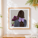 Finished woman with purple flowers and lilac bow cross stitch artwork displayed