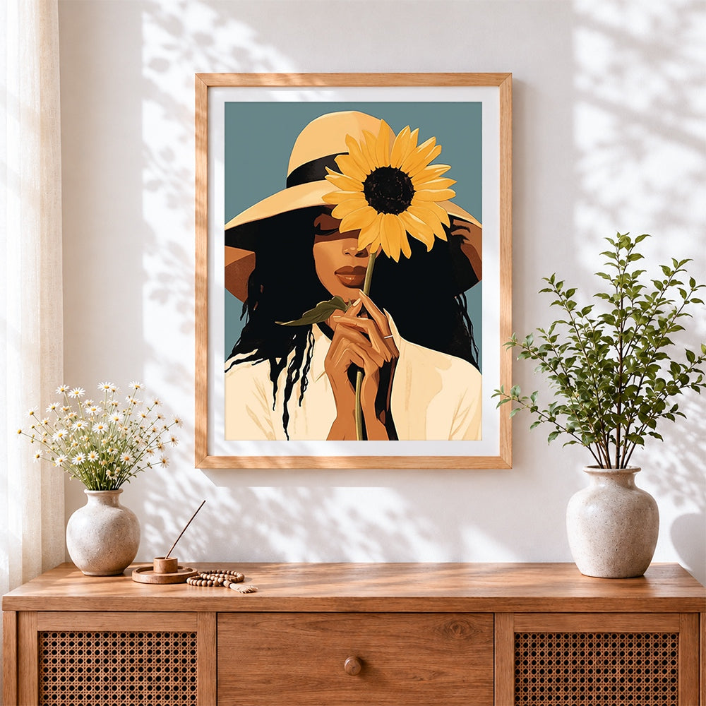 Finished woman with sunflower and straw hat cross stitch artwork displayed