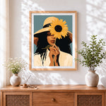 Finished woman with sunflower and straw hat cross stitch artwork displayed