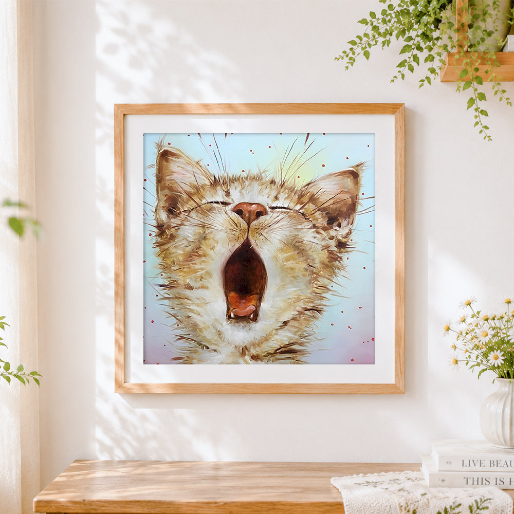 Finished yawning cat cross stitch artwork displayed