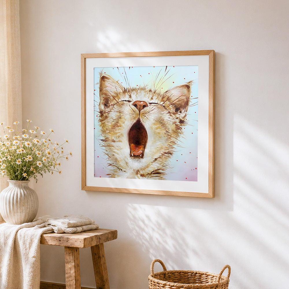 Yawning cat cross stitch artwork displayed on wall as home decor