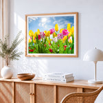 Yellow and pink tulips under blue sky cross stitch artwork displayed on wall as home decor