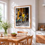 Yellow bicycle in the city cross stitch artwork displayed on wall as home decor