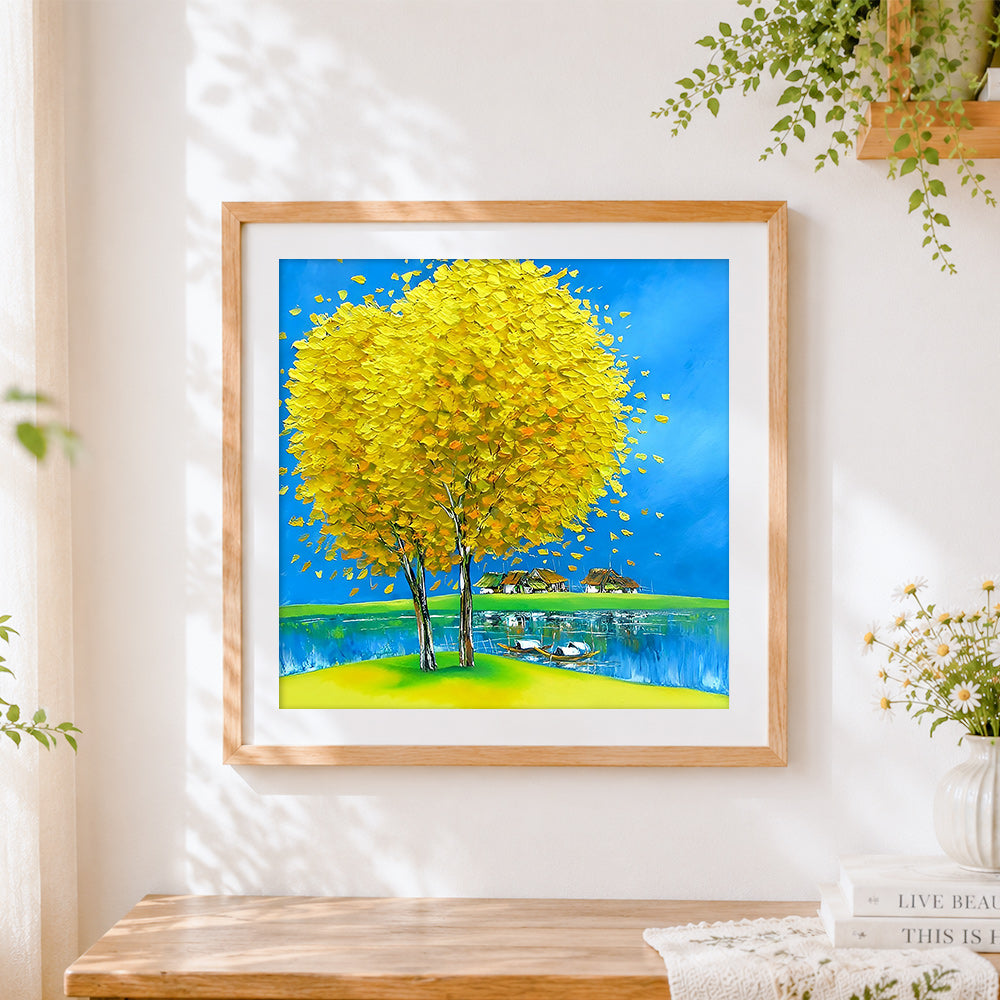 Finished yellow tree and lakeside village cross stitch artwork displayed
