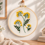 Yellow wildflower bouquet embroidery hoop wall art displayed as warm and cozy handmade home decor
