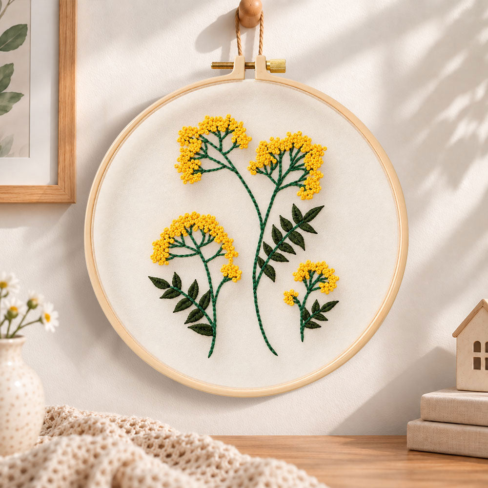 Yellow wildflower bouquet embroidery hoop wall art displayed as warm and cozy handmade home decor