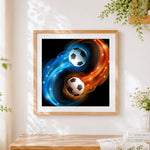 Finished yin yang footballs in fire and water cross stitch artwork displayed