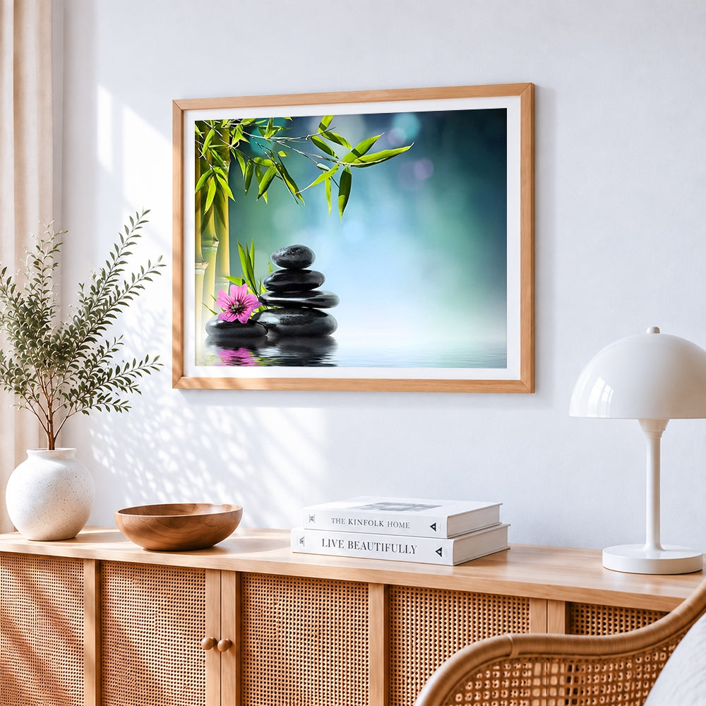 Zen spa stones with bamboo and pink flower cross stitch artwork displayed on wall as home decor