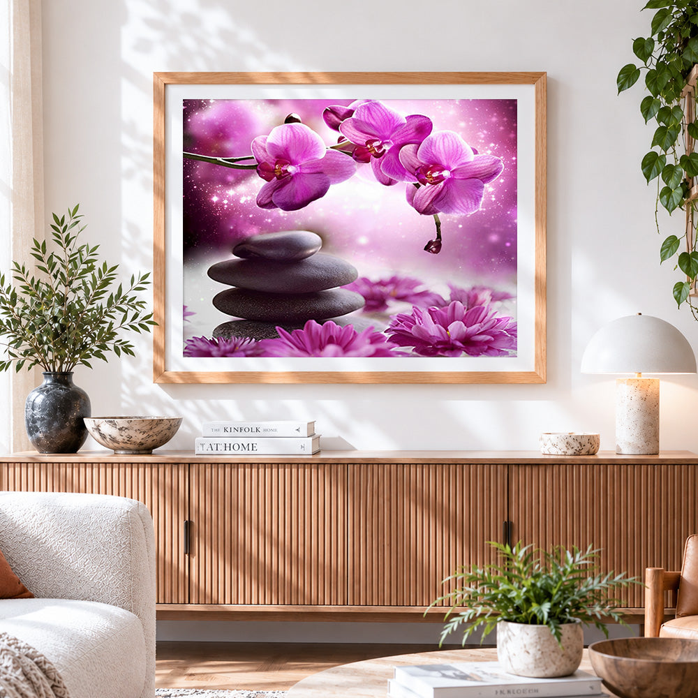Finished zen stones and pink orchids cross stitch artwork displayed