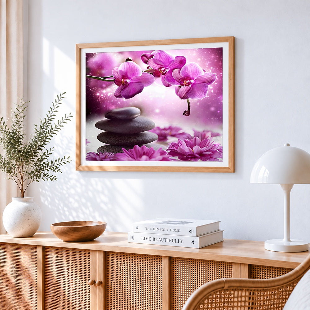 Zen stones and pink orchids cross stitch artwork displayed on wall as home decor
